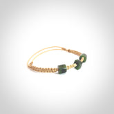 Hand carved New Zealand jade adjustable bracelet with beige cord. Carved in New Zealand jade by Ric Moor for NZ Pacific. One only armband for women and men.
